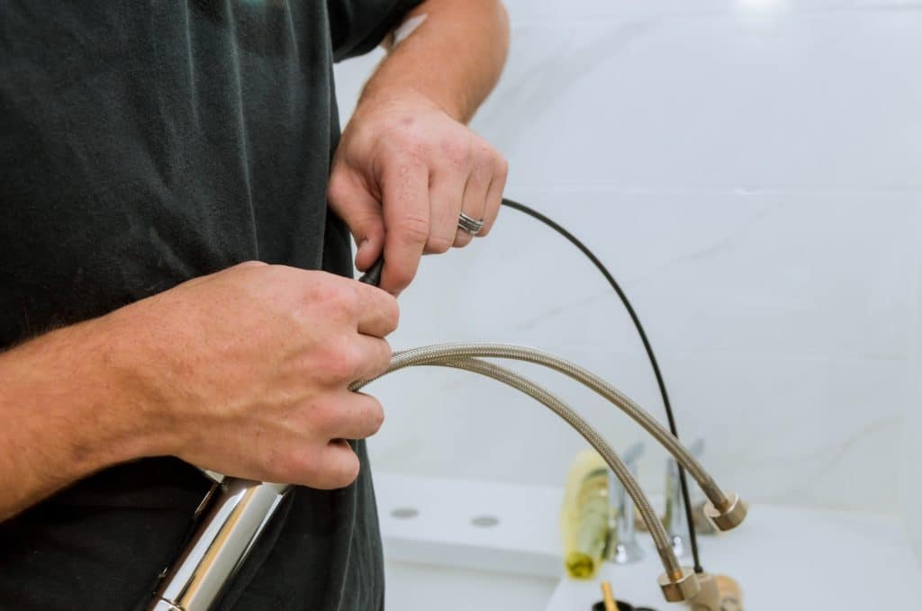 Installation of chrome faucet plumber at work in a bathroom plumbing assemble repair service