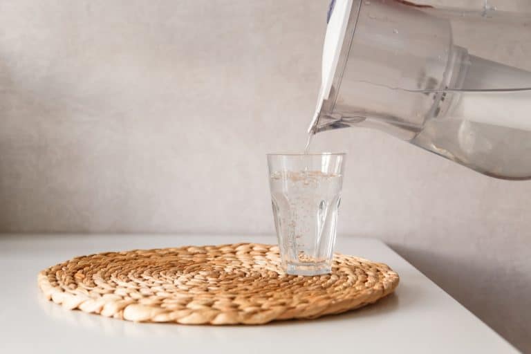 Pouring water from pitcher into a glass