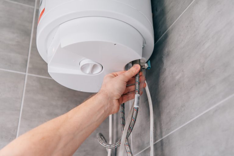 plumber connecting braided hose to hot water tank 2026 03 13 01 18 02 utc