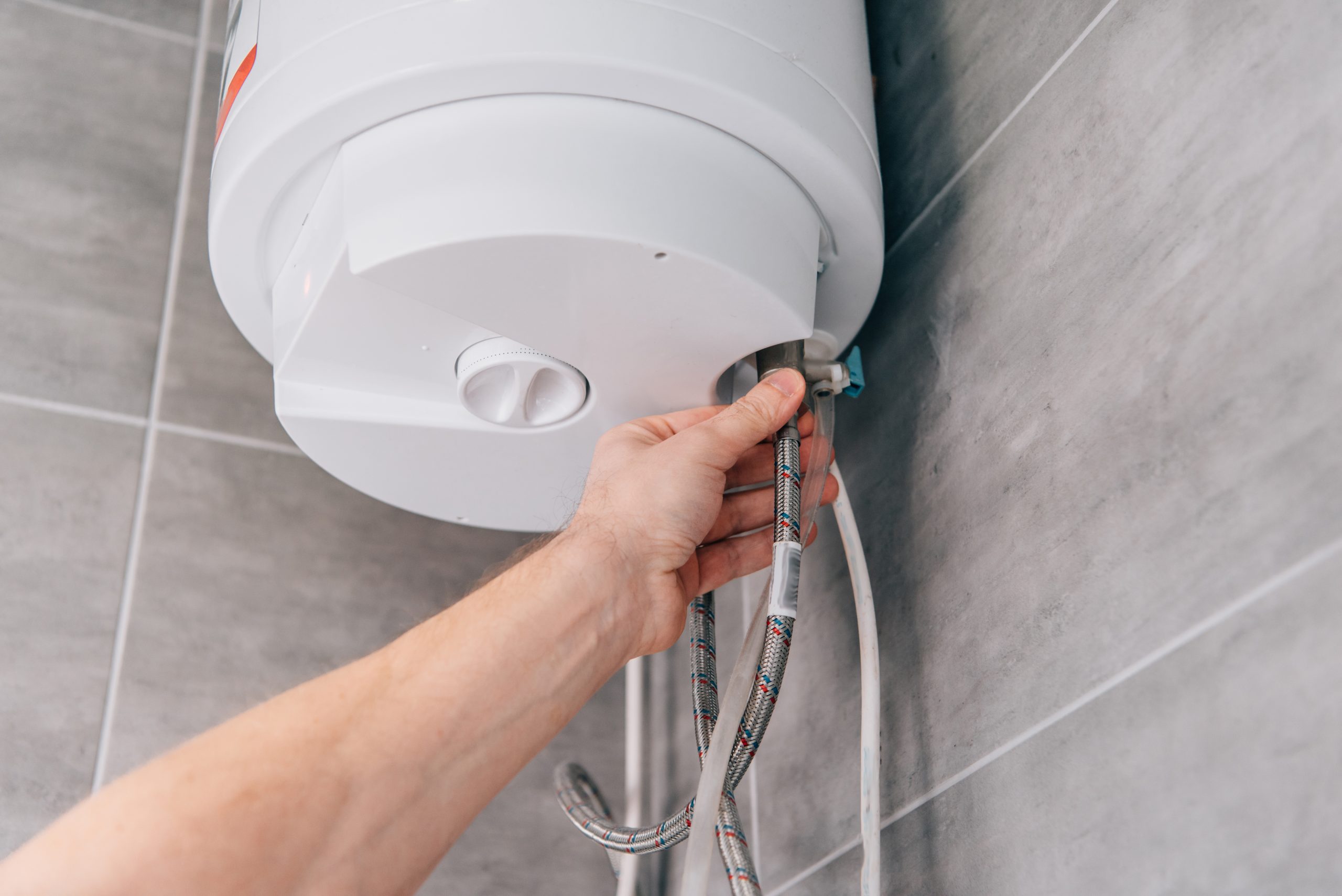 plumber connecting braided hose to hot water tank 2026 03 13 01 18 02 utc