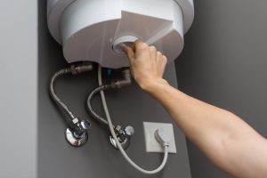 woman hands setting temperature of water in heater 2026 03 17 14 47 24 utc