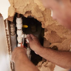 Plumbers working on pipes